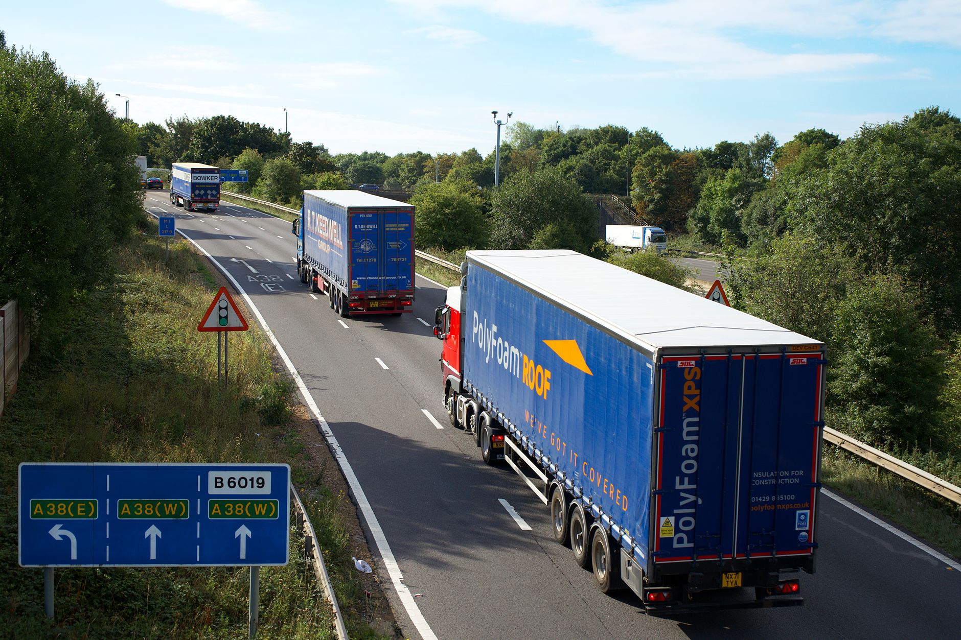 Busy UK motorway at dusk showing live traffic conditions, relevant to motorway driving apps UK
