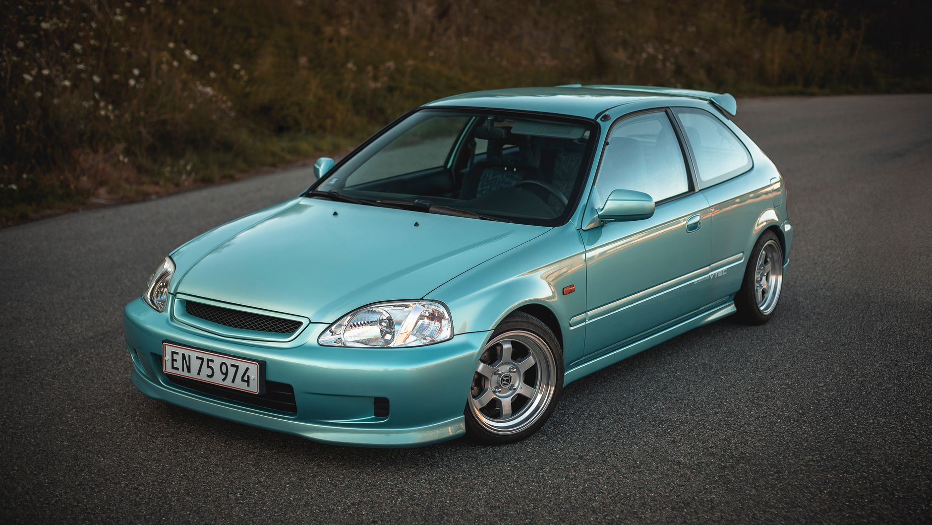 Close-up of a modified hatchback at a UK car meet culture show and shine event