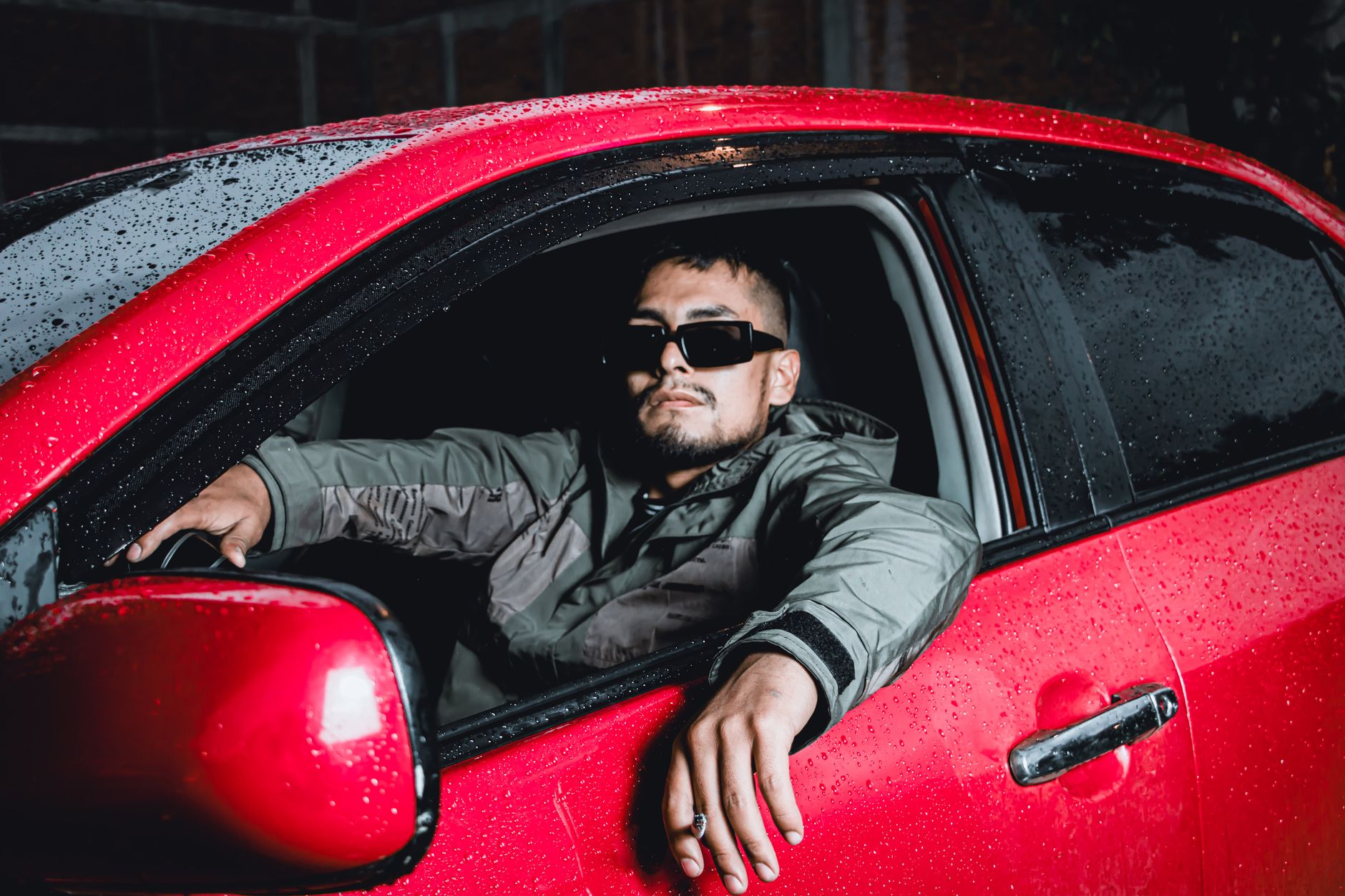 Driver wearing best polarised driving glasses UK on a motorway with low winter sun glare through windscreen