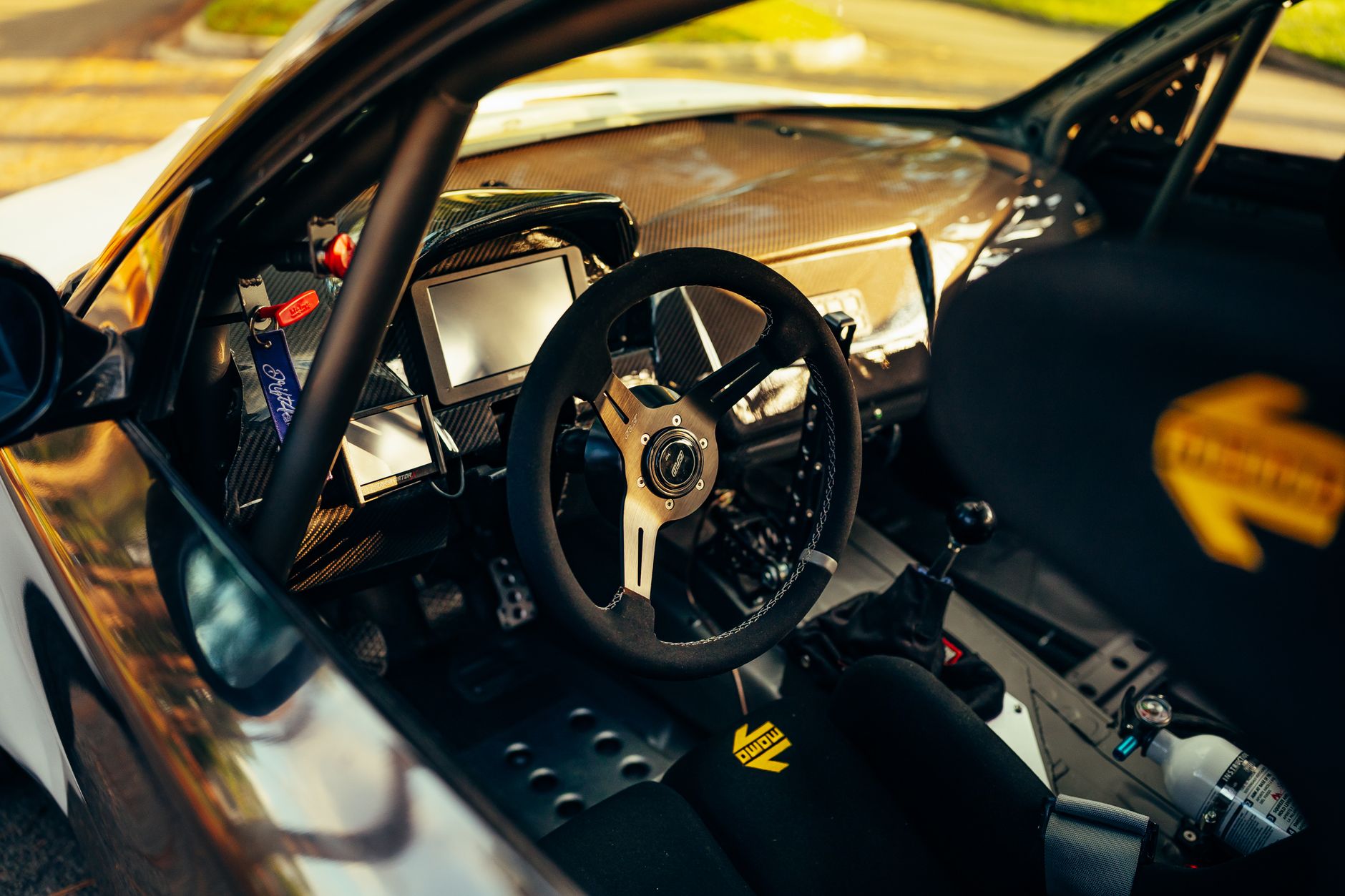 Entry-level sim racing hardware UK setup with force feedback wheel and pedals at a desk rig